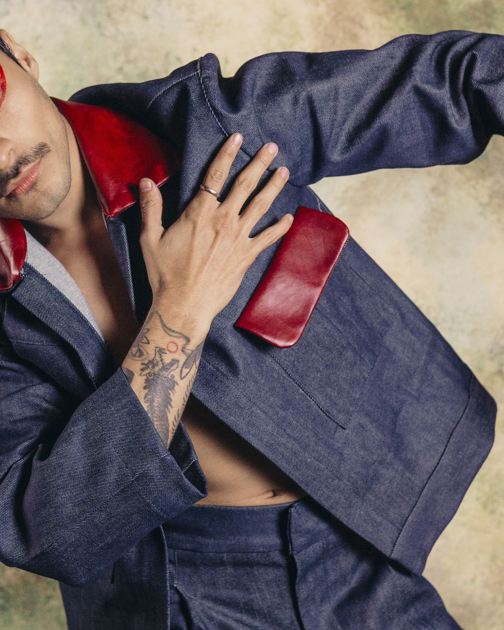 Editorial tailored portrait with sharp line and red accents expressing polish for made-to-measure